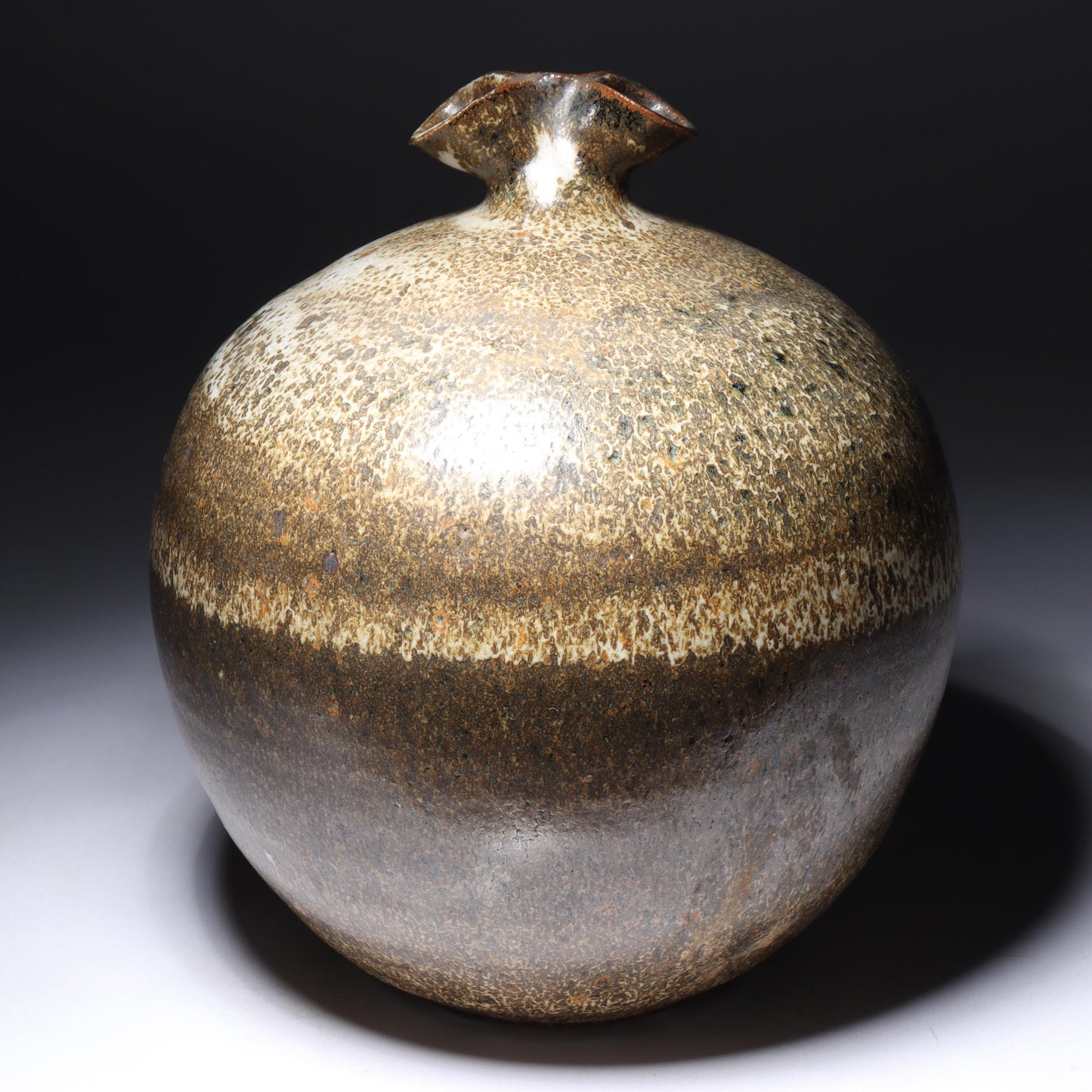 Laura Andreson, California (1902 - 1999), American studio pottery pinch neck bulbous vase, 1979, stoneware mottled banded earthtone glaze, 7 3/4"H x 6 1/2"Diam.