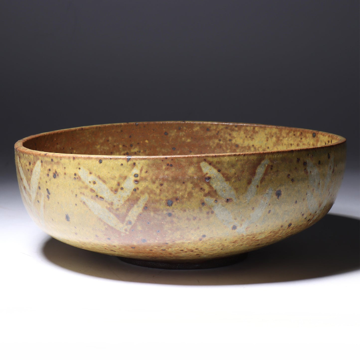Laura Andreson, California (1902 - 1999), American studio pottery bowl, 1955, stoneware with mustard over brown glaze and spatter with painted mark pattern, 3"H x 8 1/4"Diam.