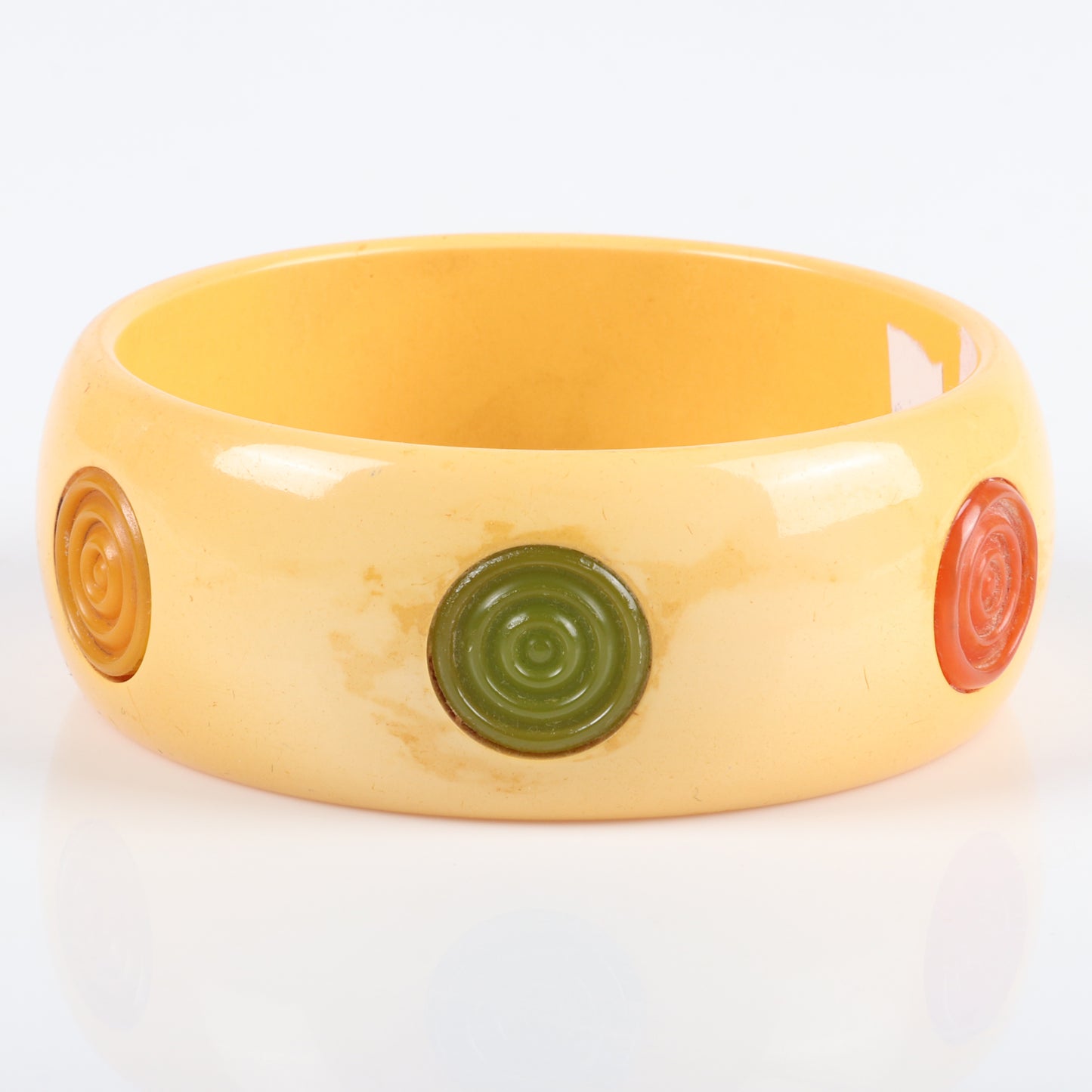 Vintage Bakelite 6 multi-color bullseye dot inset bangle bracelet. Possible glue residue. 2 1/2" inner diam., 1 1/4" W