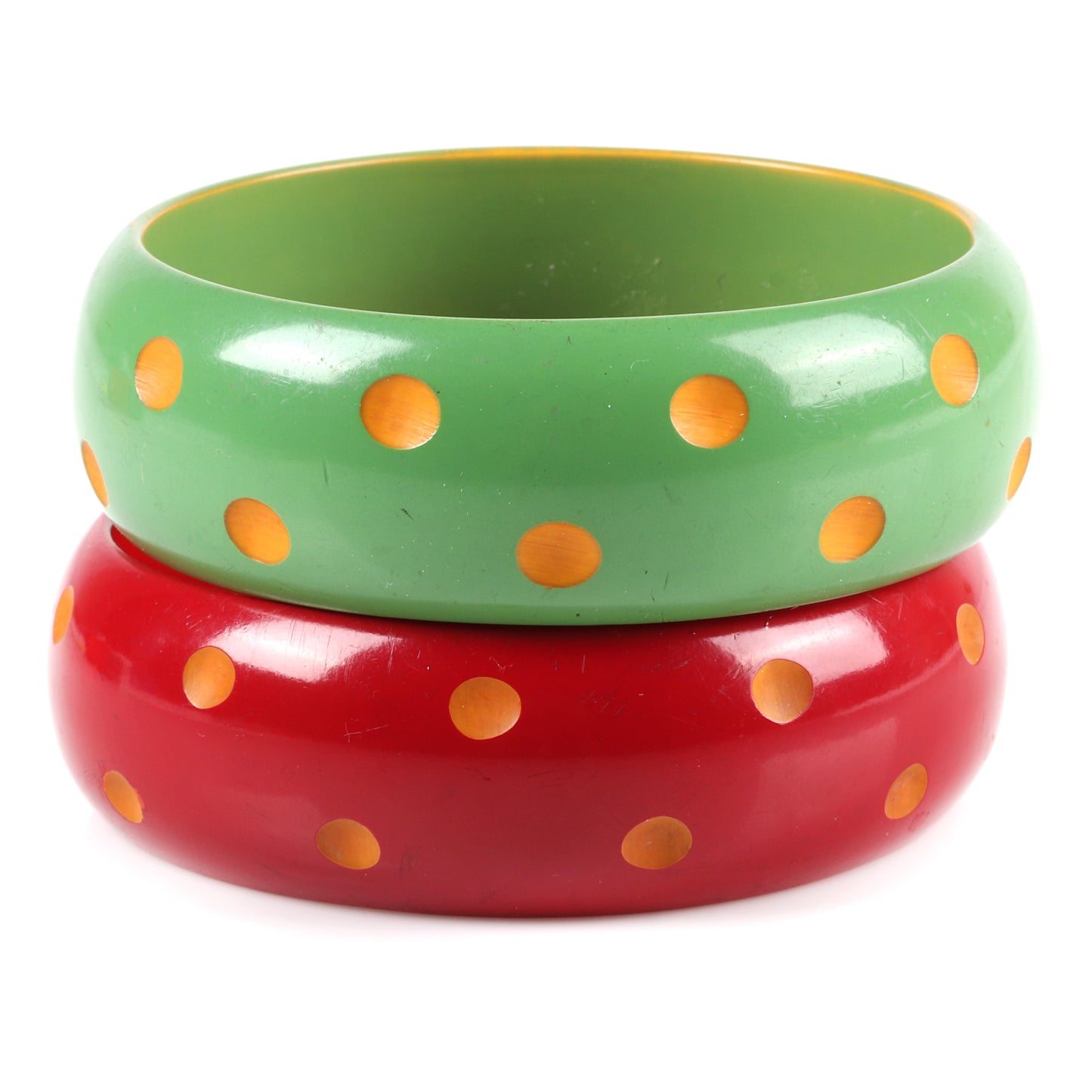 Vintage Galalith 2pc. over-dyed carved polka dot bangle bracelets, red and green with yellow dots. 2 1/2" inner diam., 1" W