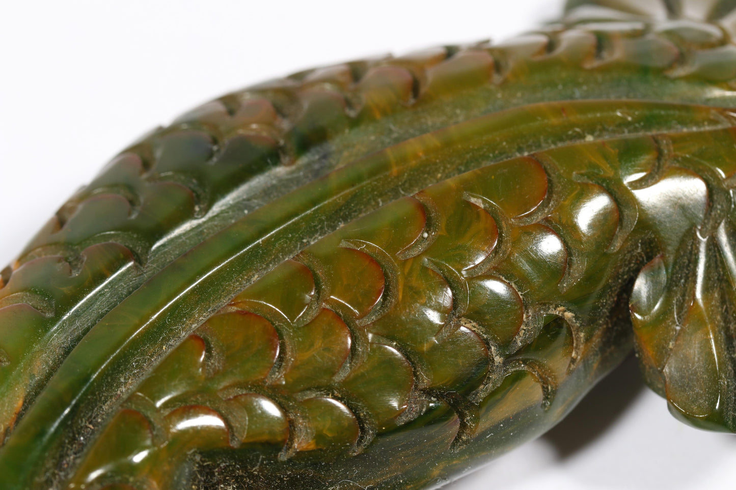 Vintage carved figural spinach Bakelite lizard brooch with glass eyes.