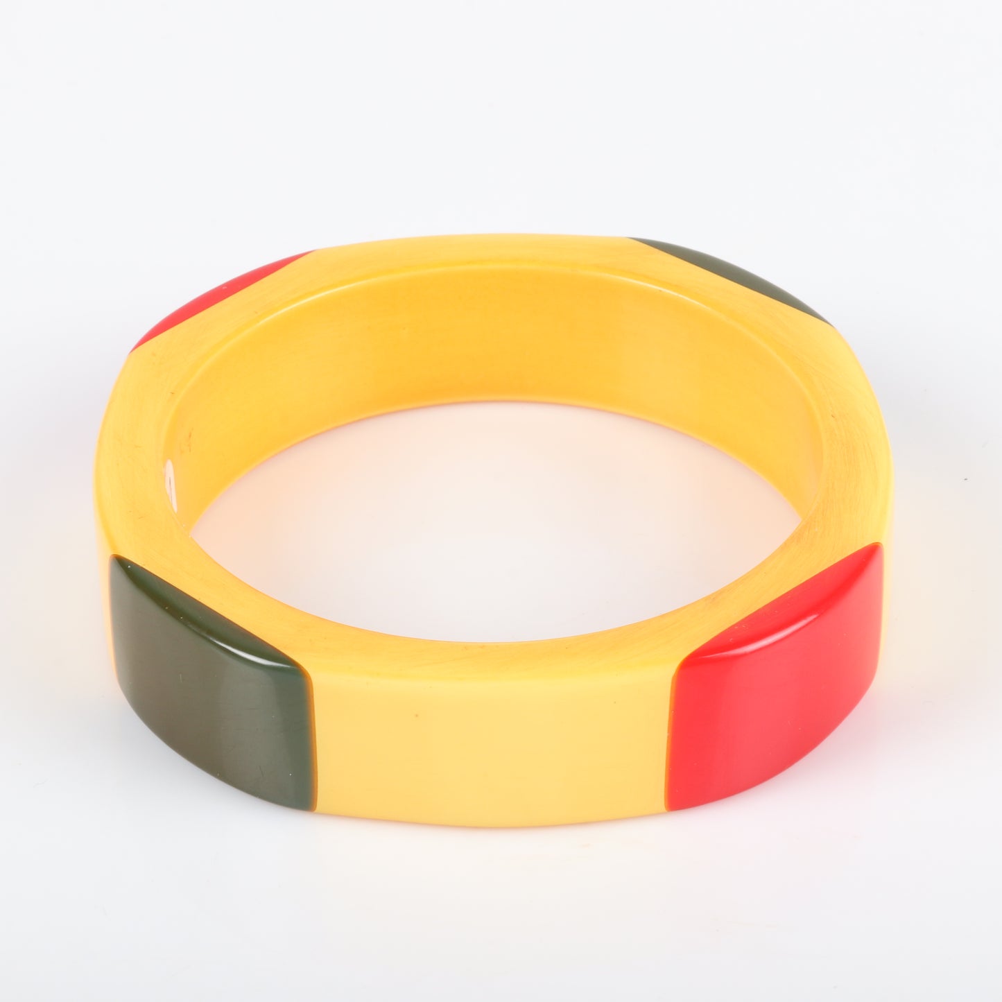 Vintage Bakelite laminated 4 sided bangle with red and green corners on cream corn colored bracelet. 2 1/2" inner diam., 3/4" W