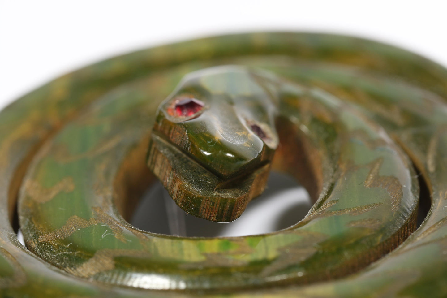 Vintage Book Piece RARE carved figural spinach Bakelite serpent snake brooch with red jeweled eyes. 2"H x 2 3/8"W