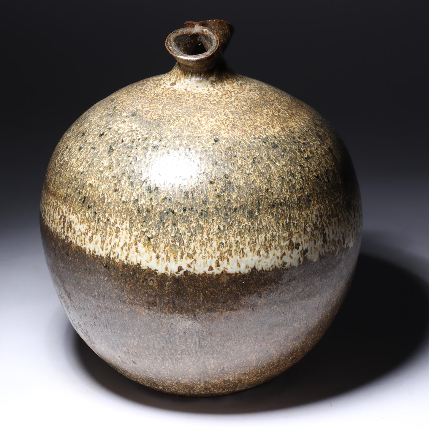 Laura Andreson, California (1902 - 1999), American studio pottery pinch neck bulbous vase, 1979, stoneware mottled banded earthtone glaze, 7 3/4"H x 6 1/2"Diam.