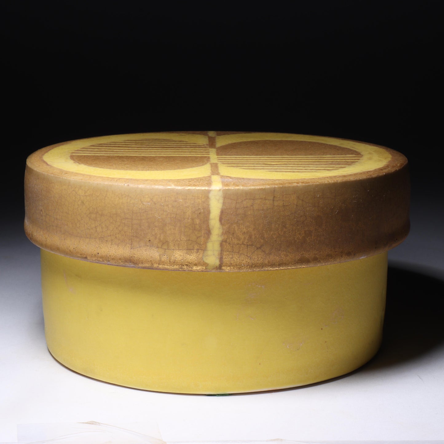 Laura Andreson, California (1902 - 1999), American studio pottery round covered porcelain box, 1975, porcelain, modernist painted design on lid in yellow and brown matte glazes, 3"H x 6"Diam.