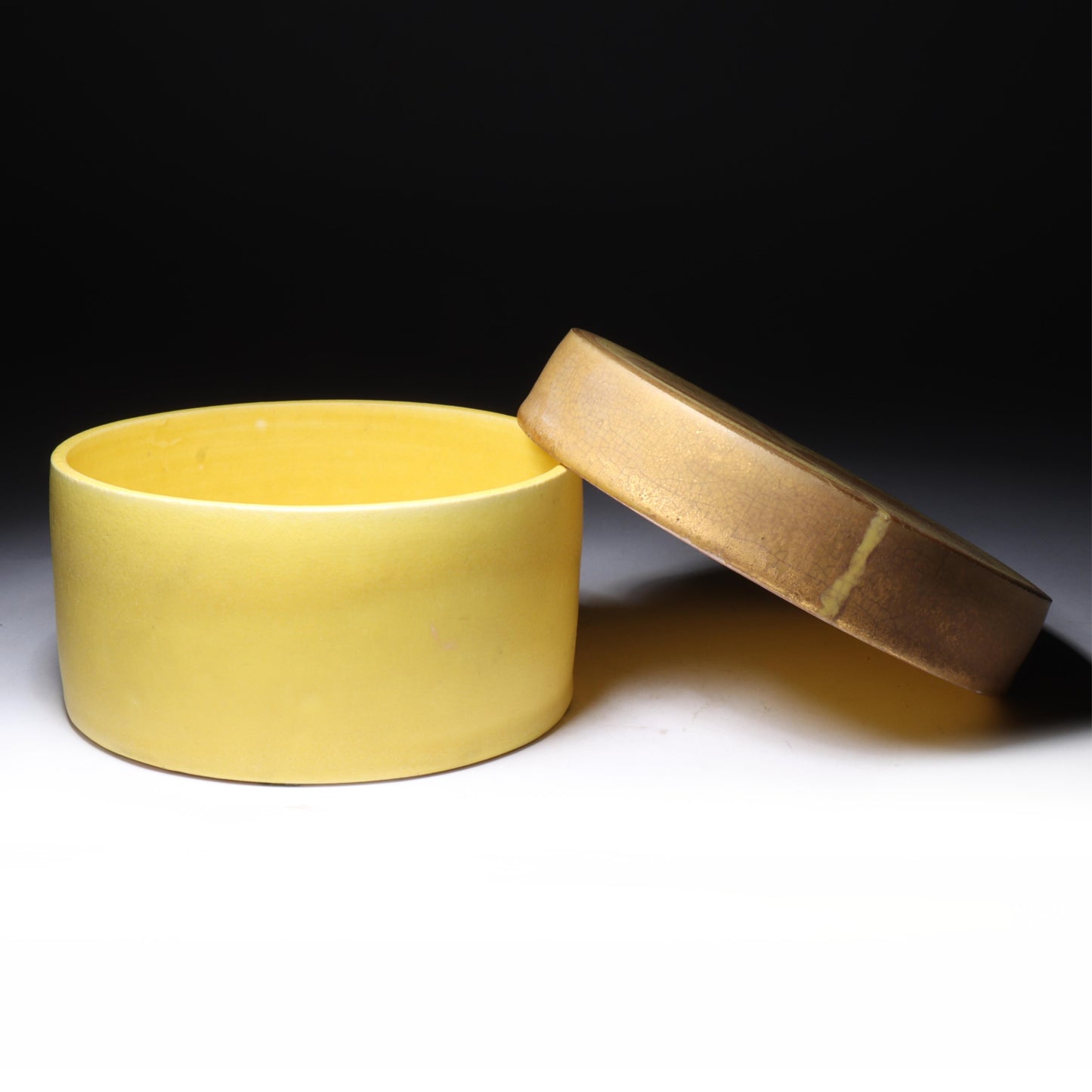Laura Andreson, California (1902 - 1999), American studio pottery round covered porcelain box, 1975, porcelain, modernist painted design on lid in yellow and brown matte glazes, 3"H x 6"Diam.