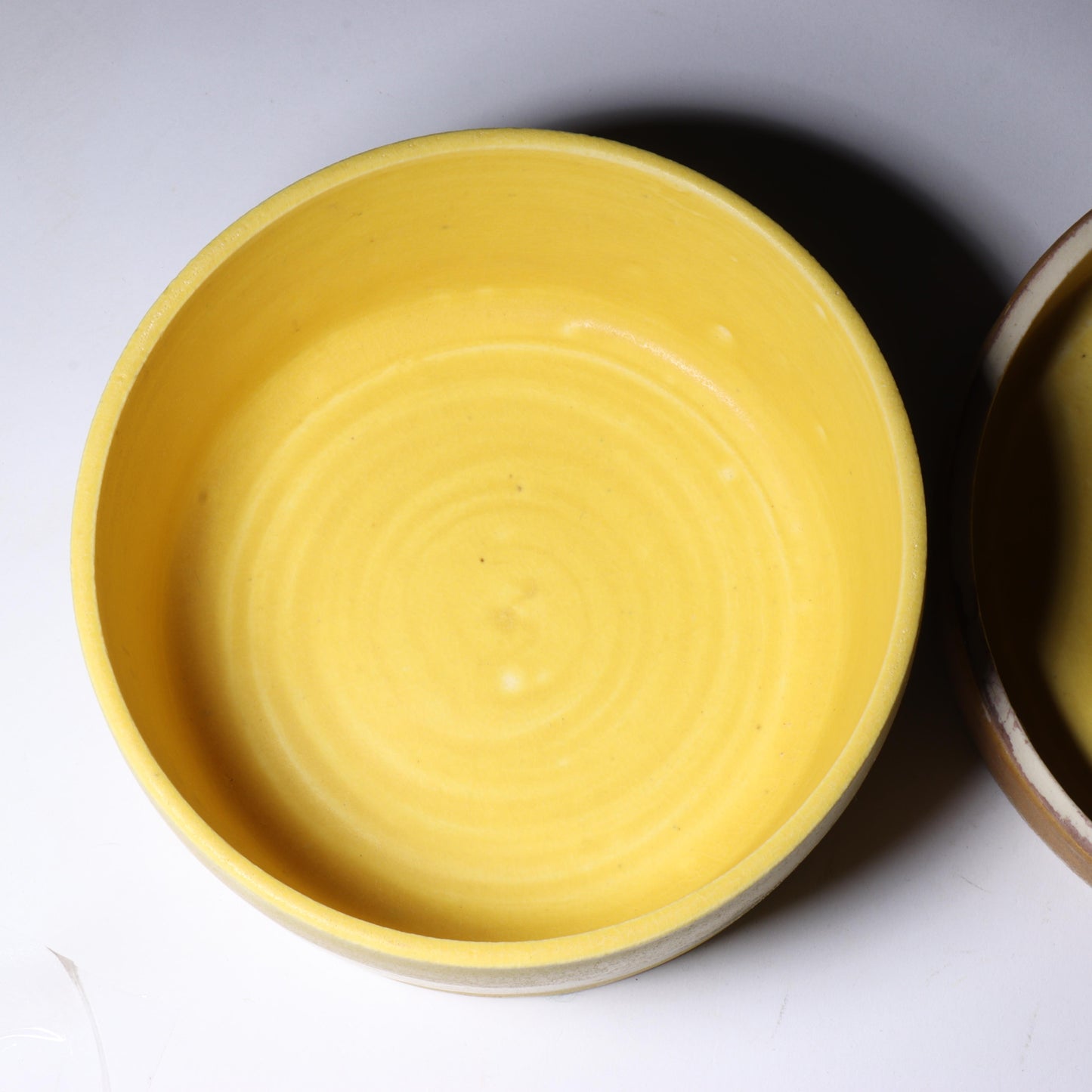 Laura Andreson, California (1902 - 1999), American studio pottery round covered porcelain box, 1975, porcelain, modernist painted design on lid in yellow and brown matte glazes, 3"H x 6"Diam.