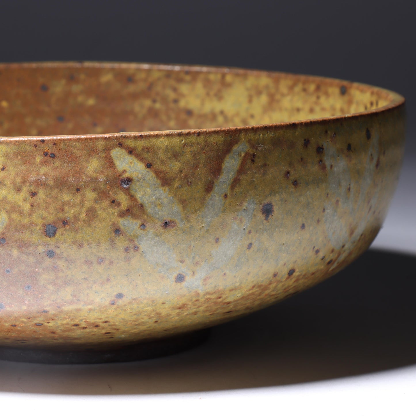 Laura Andreson, California (1902 - 1999), American studio pottery bowl, 1955, stoneware with mustard over brown glaze and spatter with painted mark pattern, 3"H x 8 1/4"Diam.