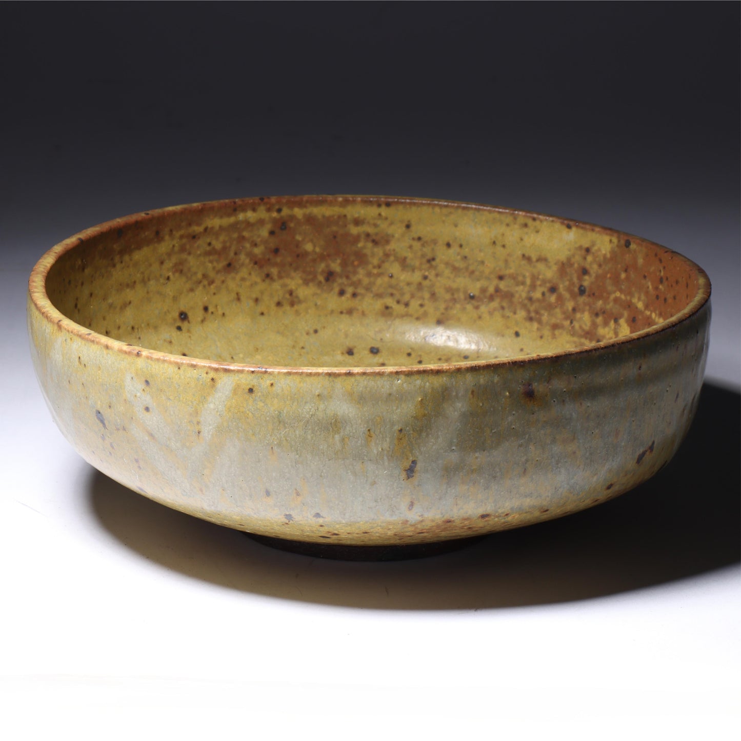 Laura Andreson, California (1902 - 1999), American studio pottery bowl, 1955, stoneware with mustard over brown glaze and spatter with painted mark pattern, 3"H x 8 1/4"Diam.