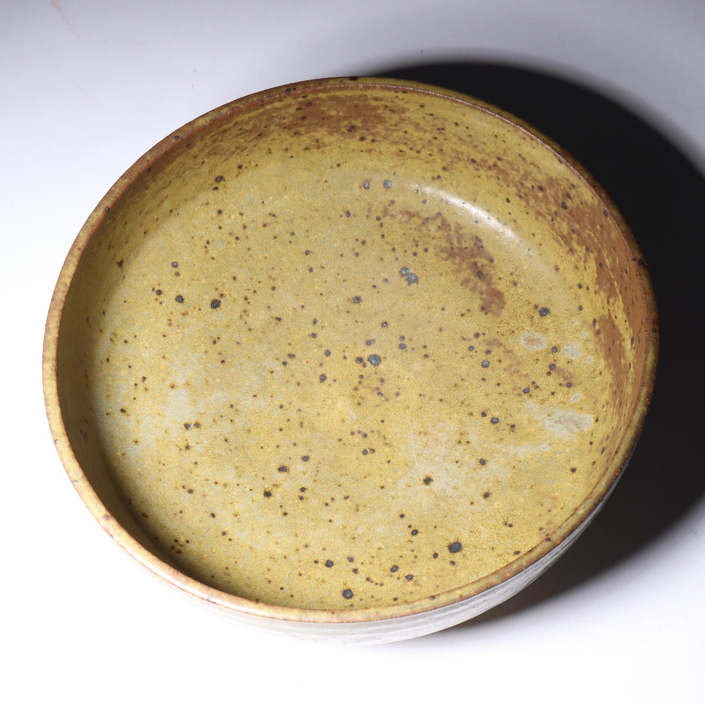 Laura Andreson, California (1902 - 1999), American studio pottery bowl, 1955, stoneware with mustard over brown glaze and spatter with painted mark pattern, 3"H x 8 1/4"Diam.