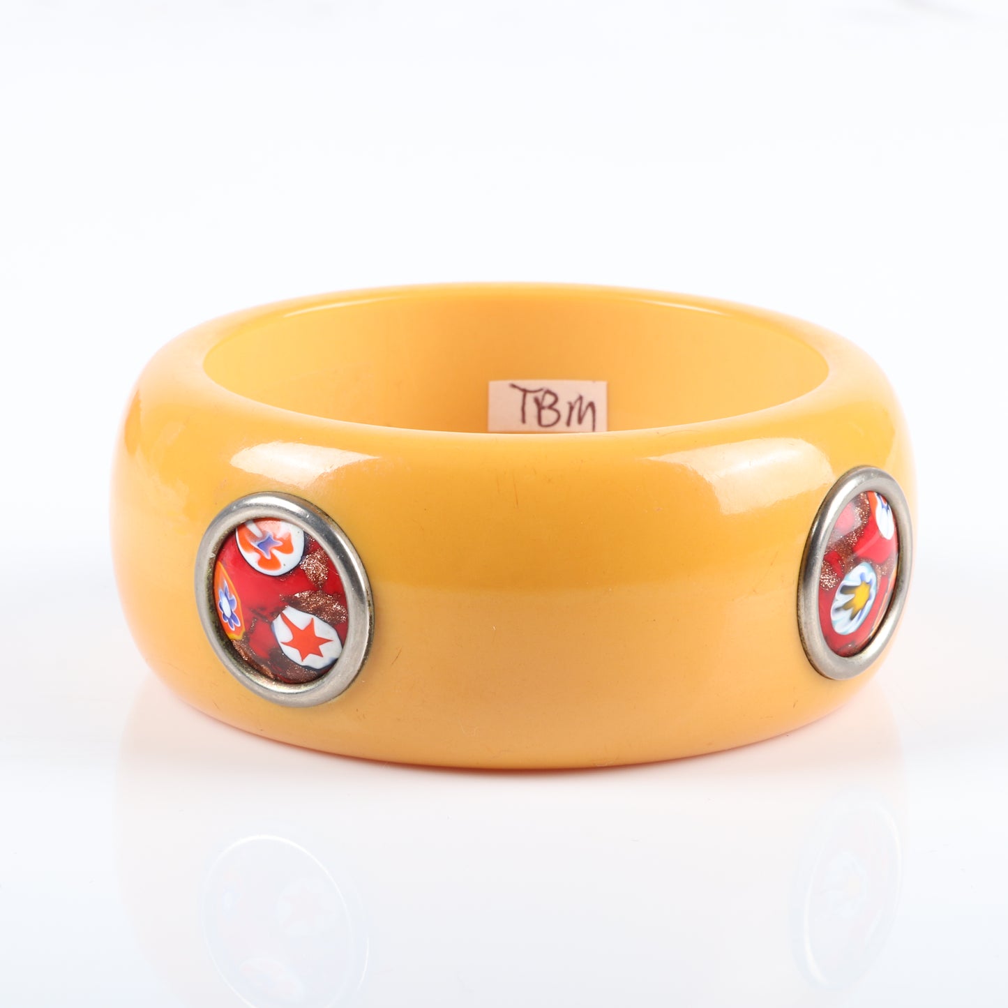 Vintage Bakelite WIDE bangle bracelet with Murano glass dots. WIDE butterscotch bangle with 4 inset Italian millefiore red art glass inlaid discs set with metal ring surround. 2 1/2" inner diam., 1 1/2" W