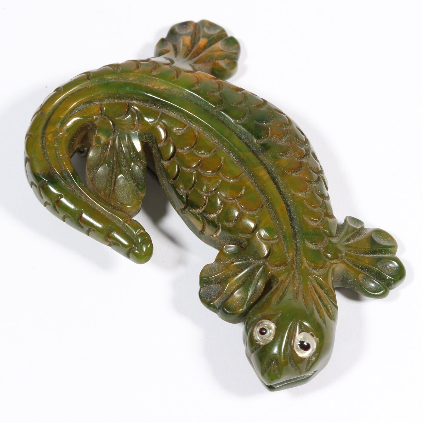 Vintage carved figural spinach Bakelite lizard brooch with glass eyes.