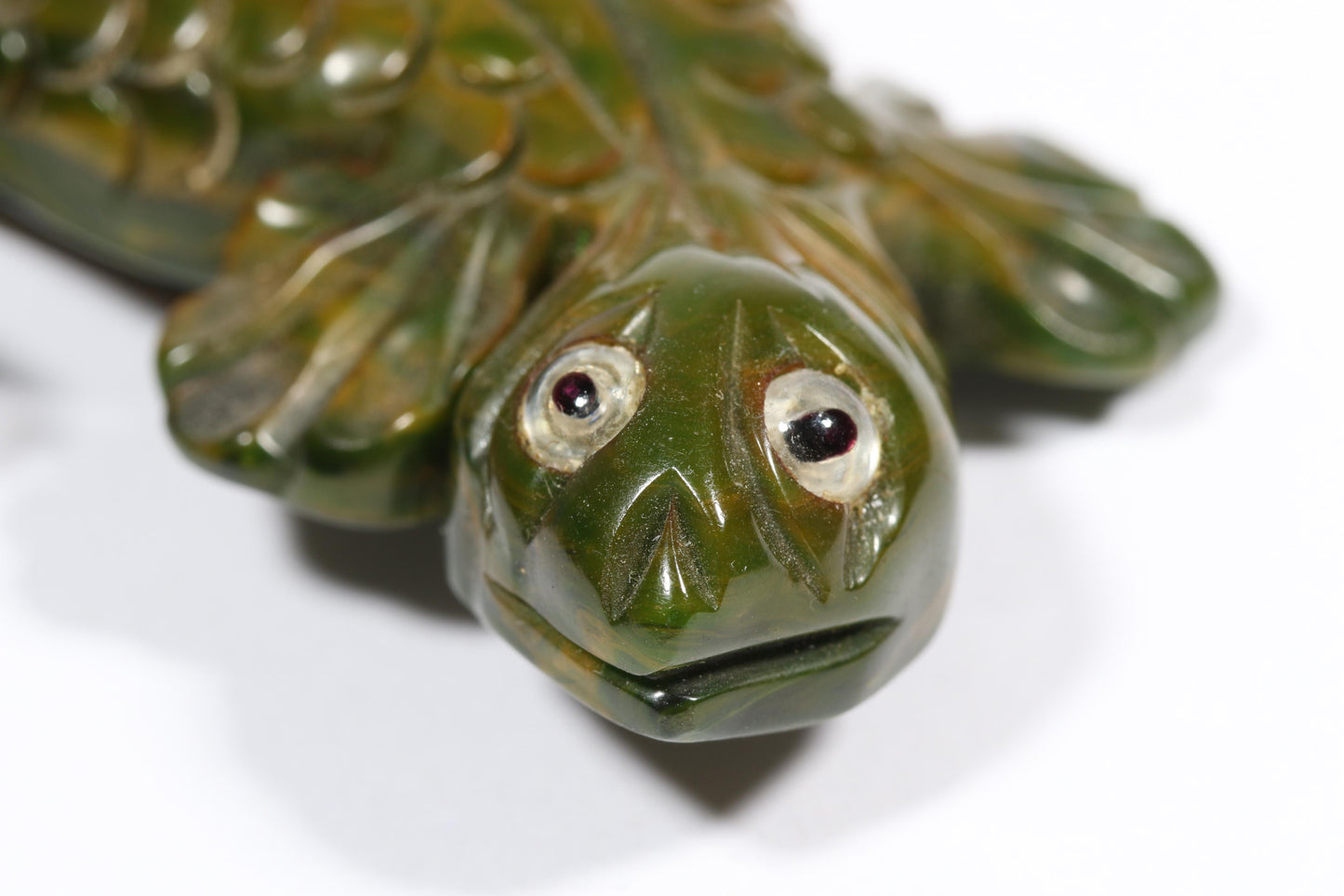 Vintage carved figural spinach Bakelite lizard brooch with glass eyes.
