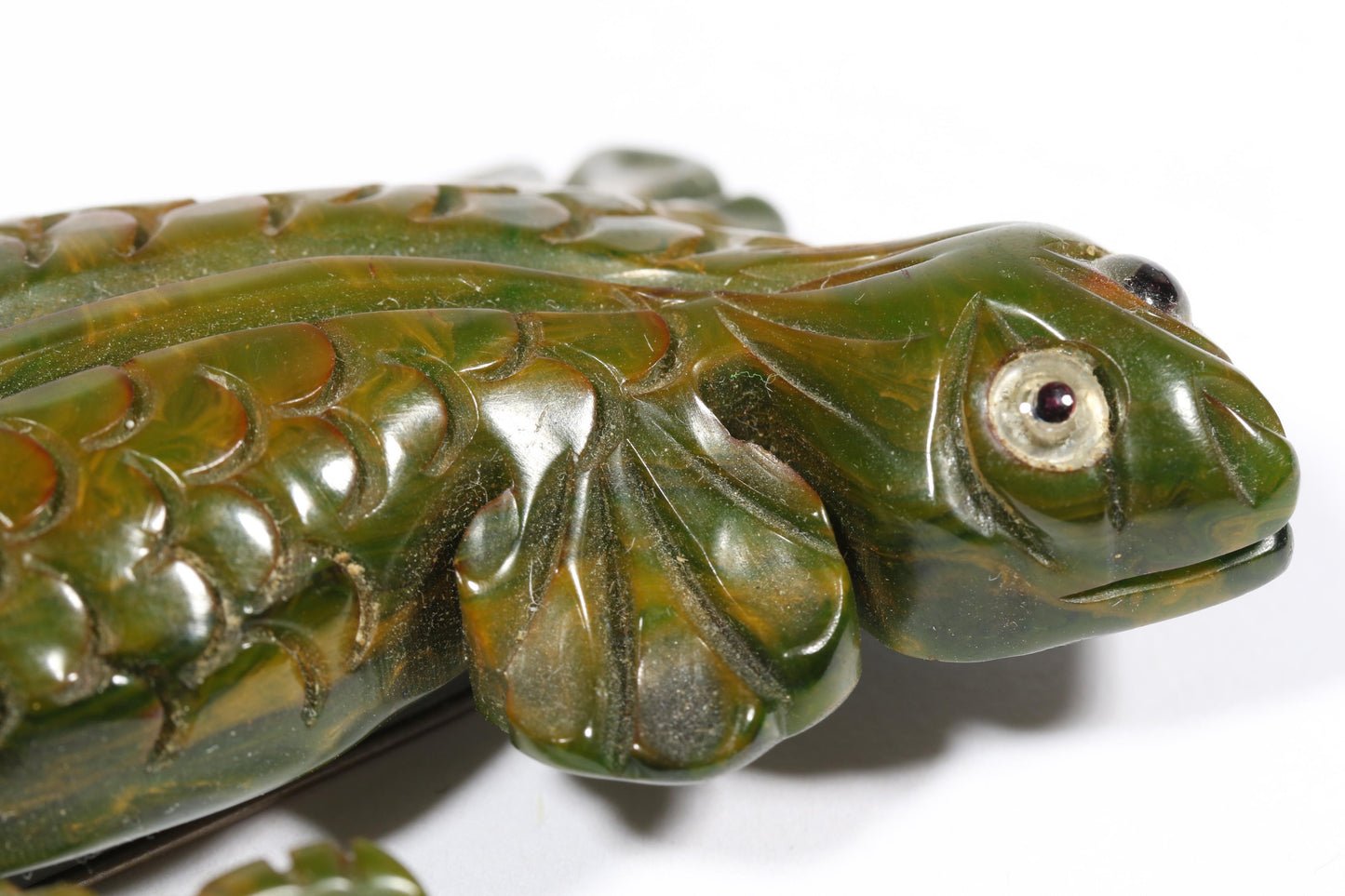Vintage carved figural spinach Bakelite lizard brooch with glass eyes.