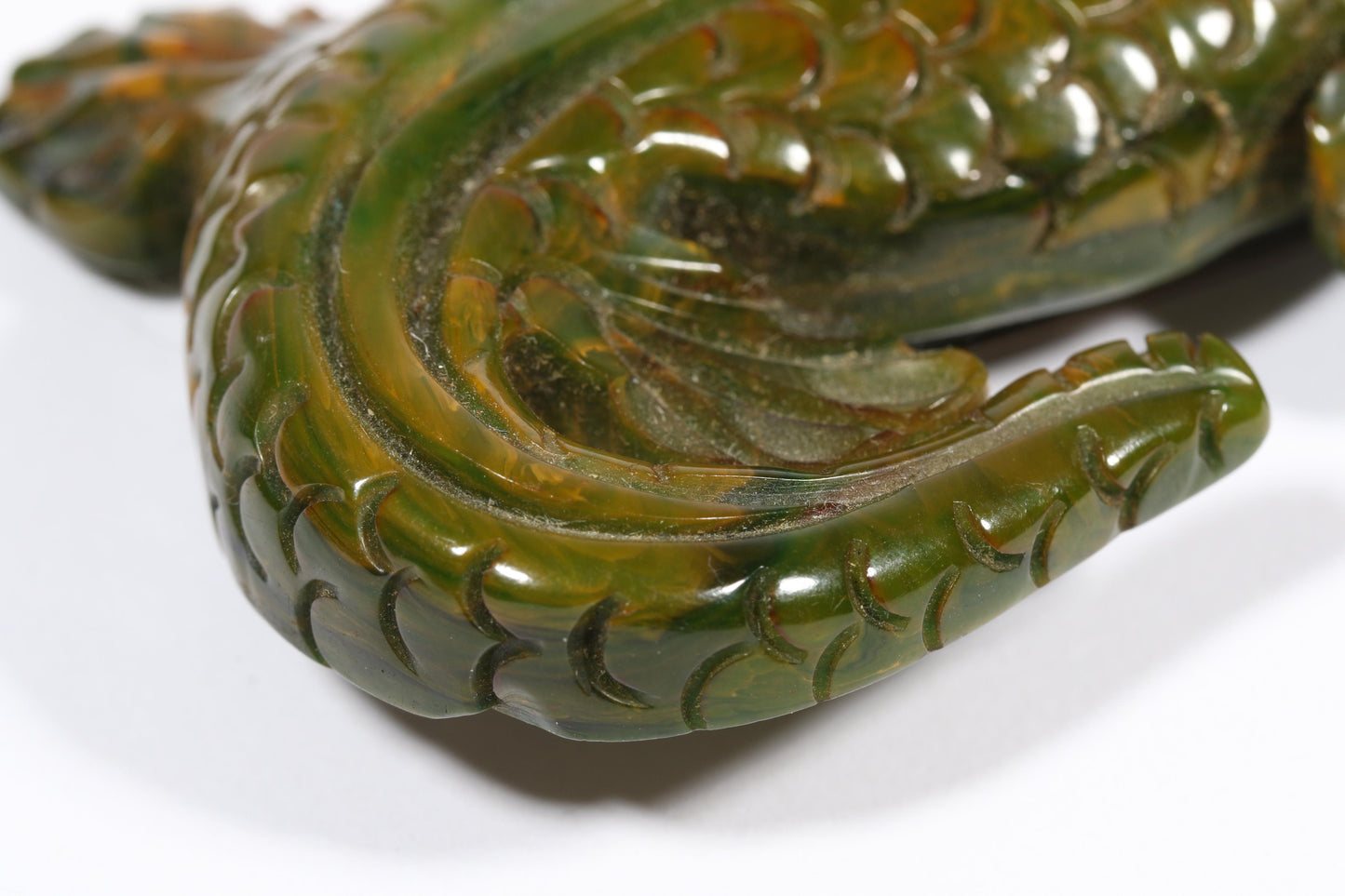 Vintage carved figural spinach Bakelite lizard brooch with glass eyes.