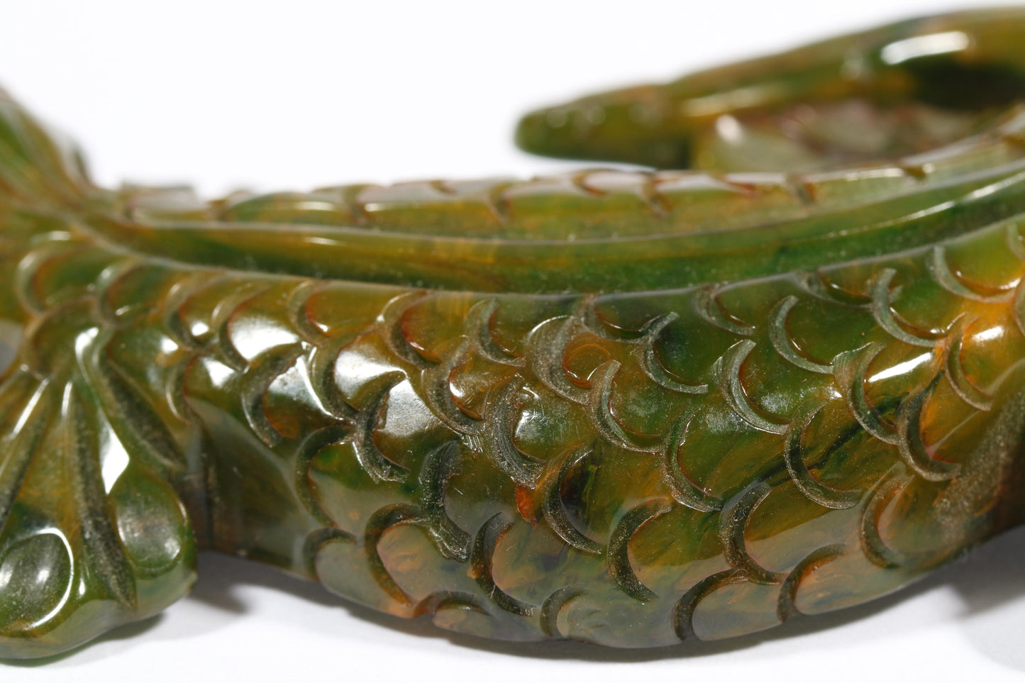Vintage carved figural spinach Bakelite lizard brooch with glass eyes.