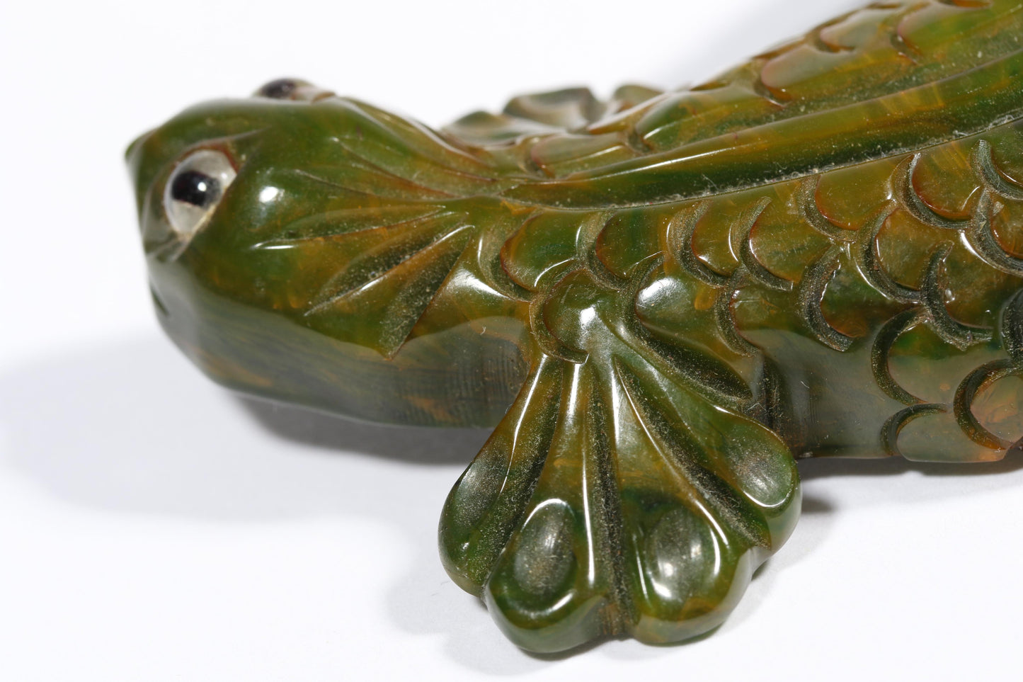 Vintage carved figural spinach Bakelite lizard brooch with glass eyes.