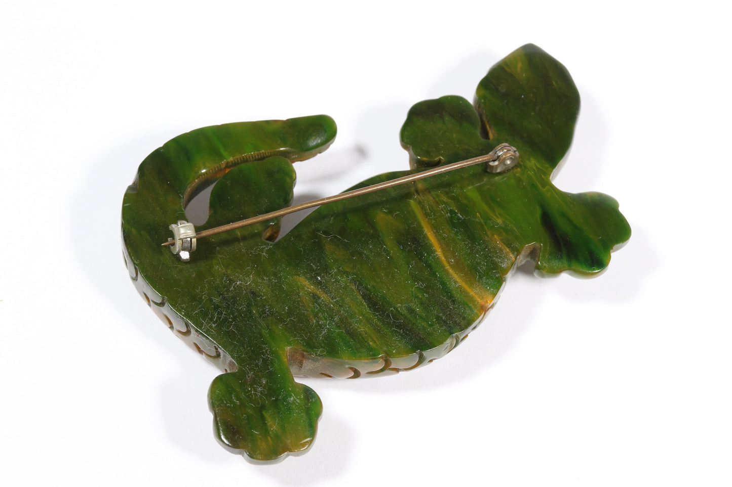 Vintage carved figural spinach Bakelite lizard brooch with glass eyes.