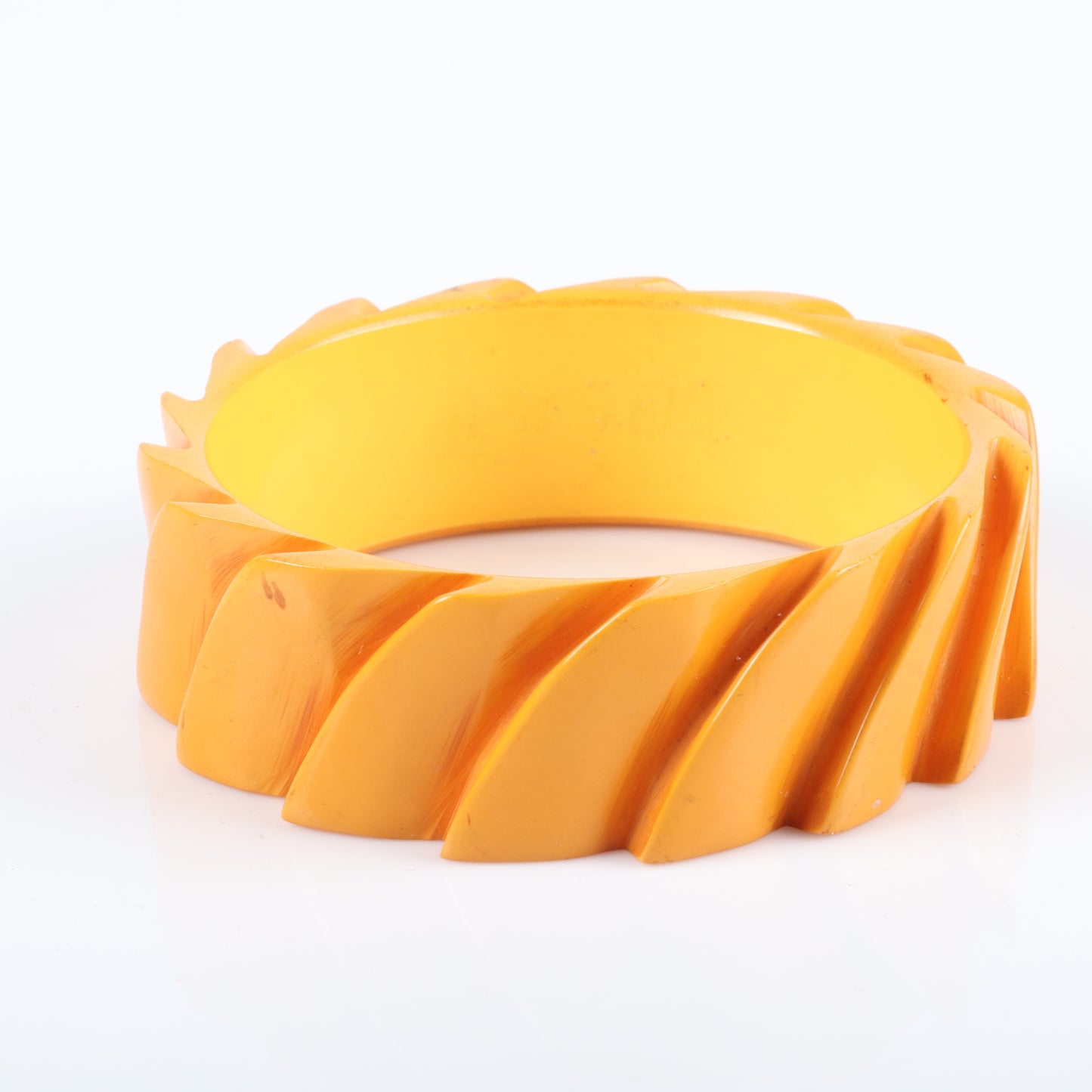 Vintage Bakelite set of 2 carved cuff bangle bracelets in butterscotch with leaf and modernist stepped machine age designs. 2 1/2" inner diam., 1.1/2" W