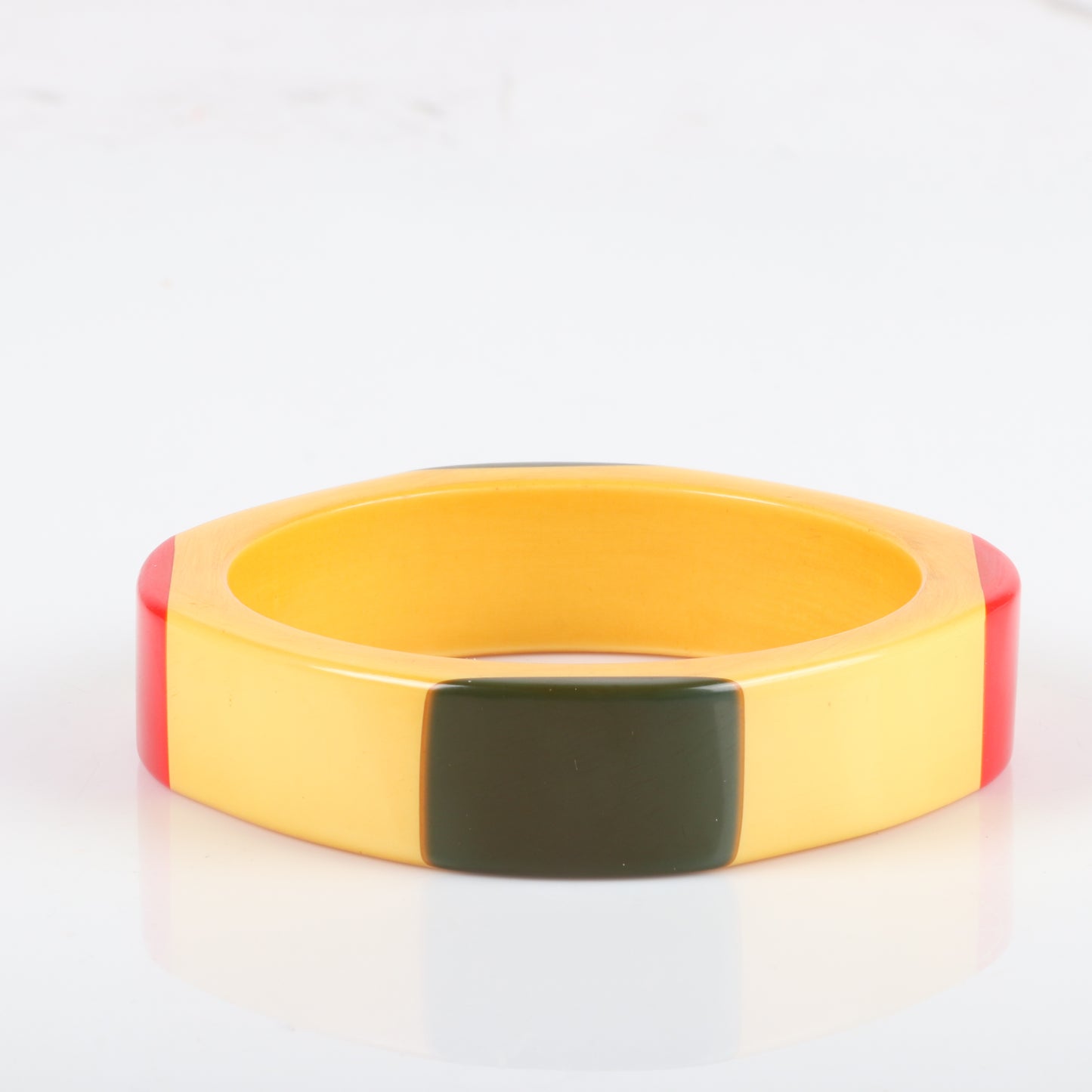 Vintage Bakelite laminated 4 sided bangle with red and green corners on cream corn colored bracelet. 2 1/2" inner diam., 3/4" W