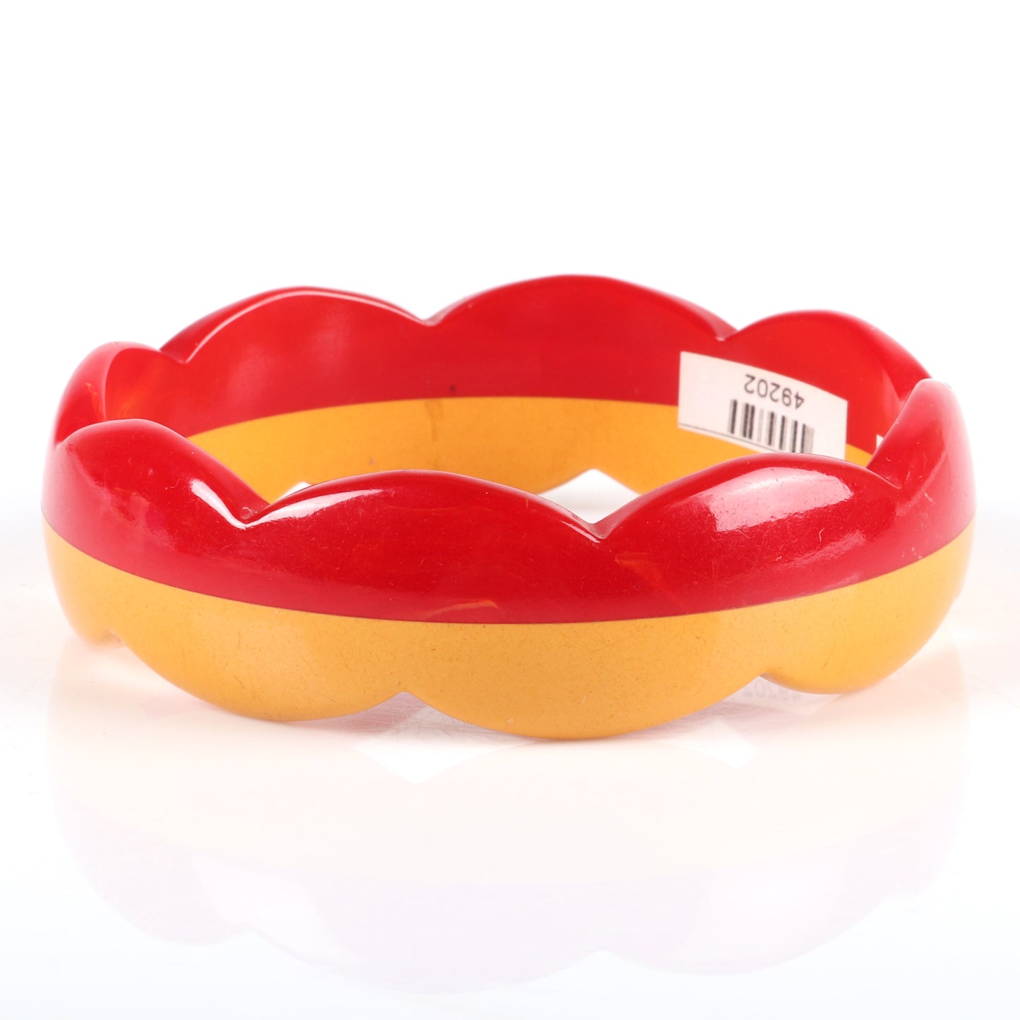 Vintage Bakelite laminated scallop carved bangle bracelet. Two color half marbled red and butterscotch. 2 1/2" inner diam., 1" W