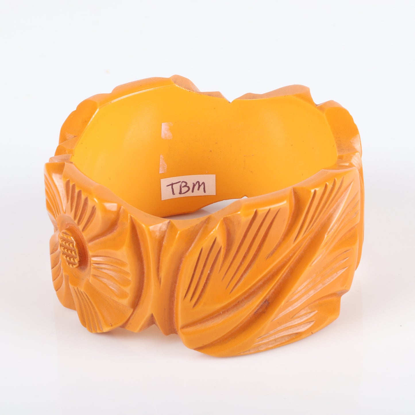 Vintage Bakelite WIDE shaped carved flower cuff bangle bracelet with alternating sunflower and leaf motif in butterscotch. 21/2" inner diam., 1 1/2" W