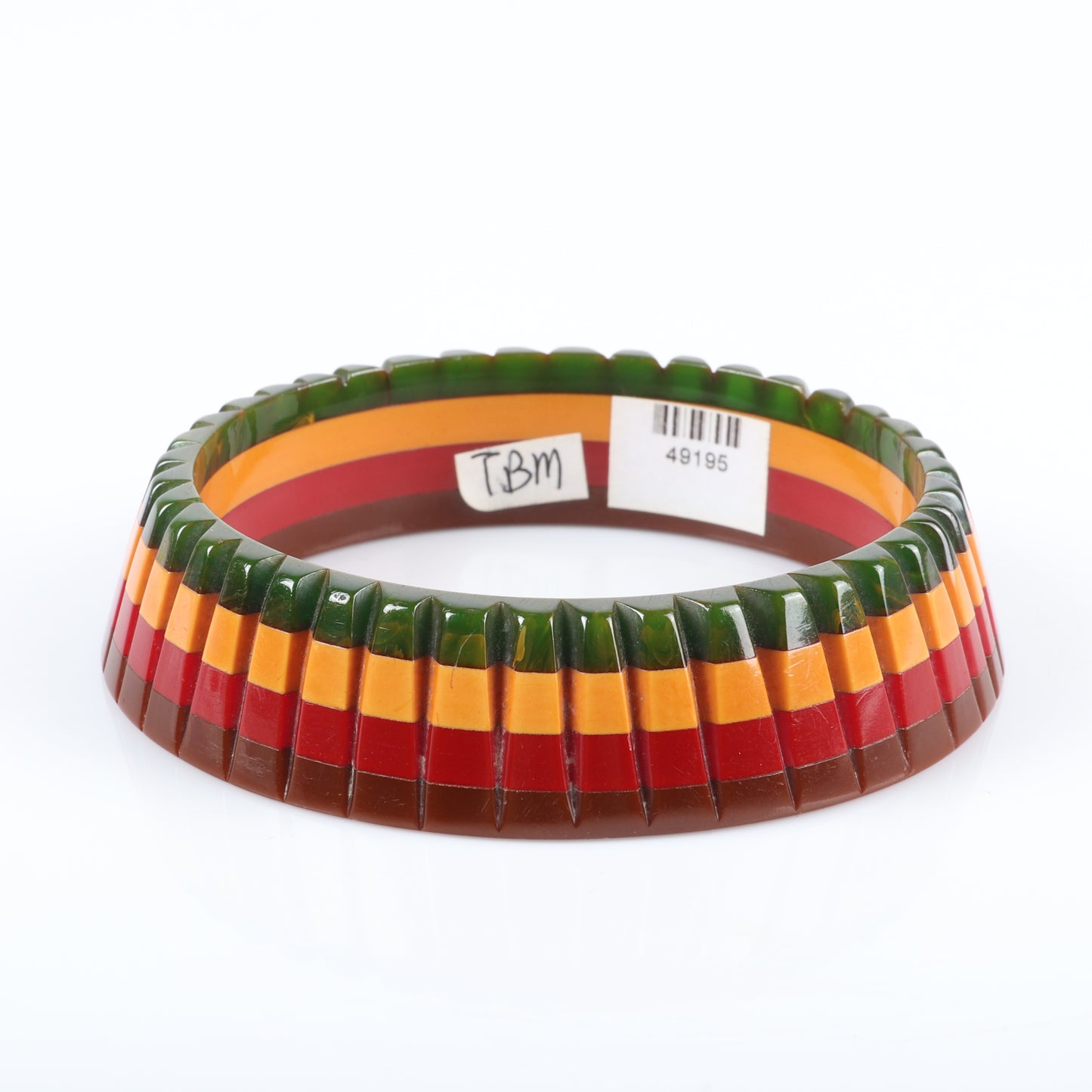 Vintage Bakelite 4 color carved laminated bangle bracelet in layers of green, cream, red, and brown. 2 3/4" inner diam.