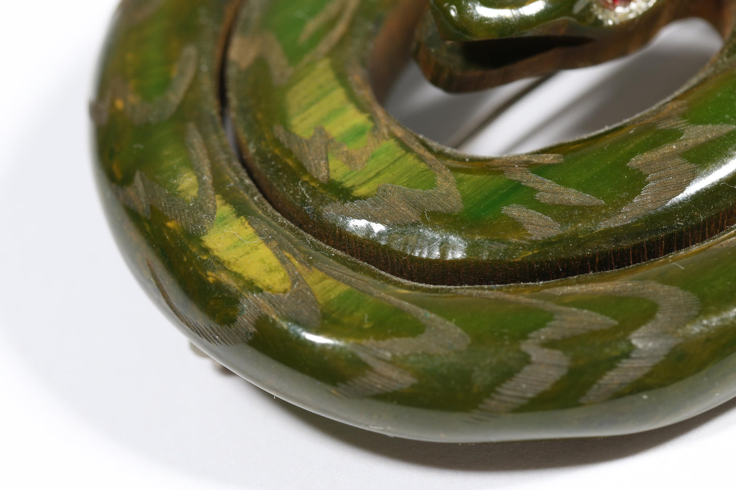 Vintage Book Piece RARE carved figural spinach Bakelite serpent snake brooch with red jeweled eyes. 2"H x 2 3/8"W