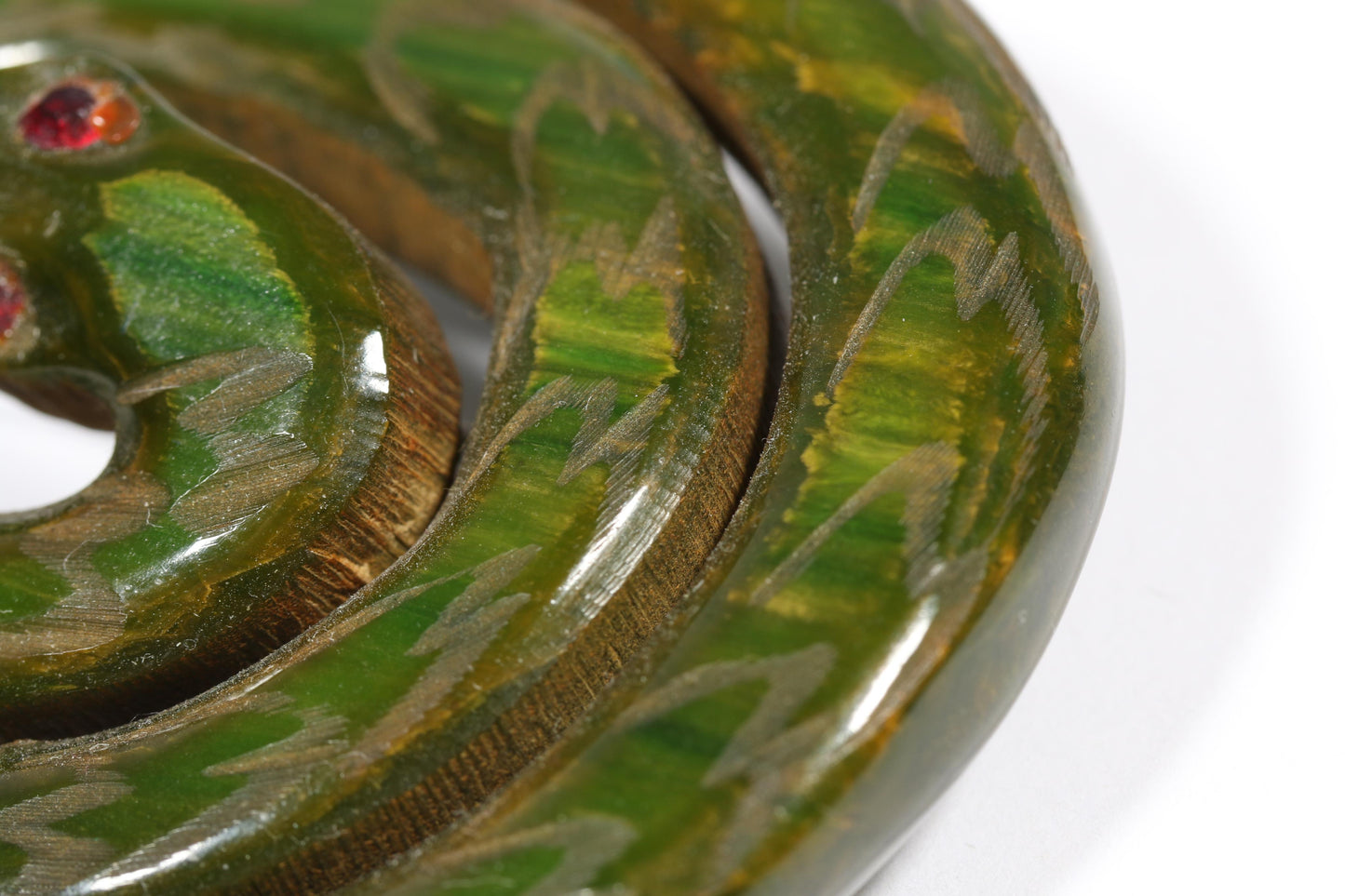 Vintage Book Piece RARE carved figural spinach Bakelite serpent snake brooch with red jeweled eyes. 2"H x 2 3/8"W