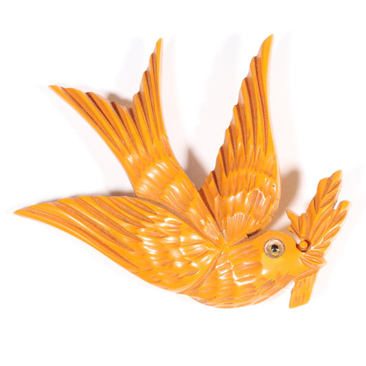 Vintage carved figural butterscotch Bakelite dove bird brooch with glass eyes. 2 1/2"H x 3"W