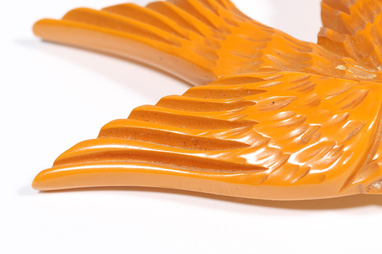 Vintage carved figural butterscotch Bakelite dove bird brooch with glass eyes. 2 1/2"H x 3"W