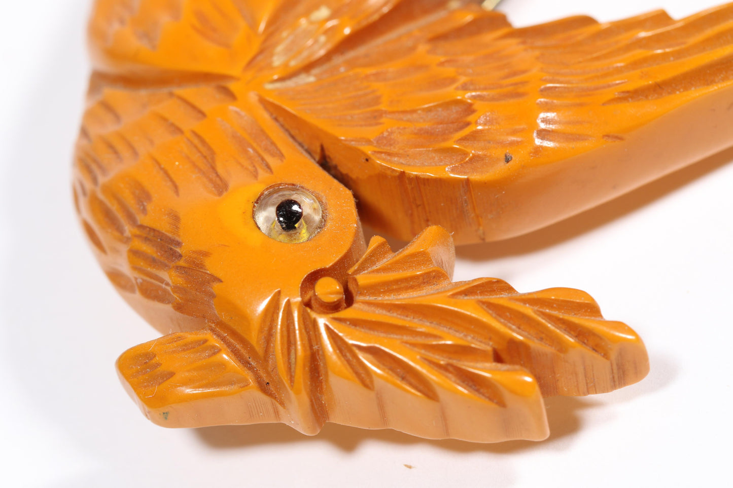Vintage carved figural butterscotch Bakelite dove bird brooch with glass eyes. 2 1/2"H x 3"W