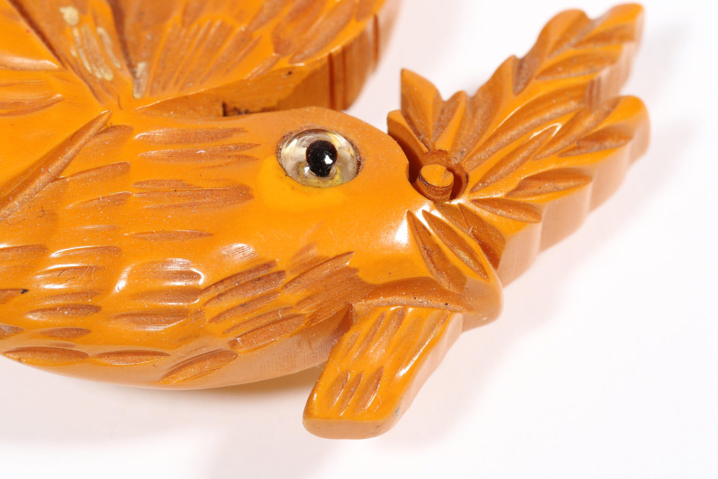 Vintage carved figural butterscotch Bakelite dove bird brooch with glass eyes. 2 1/2"H x 3"W