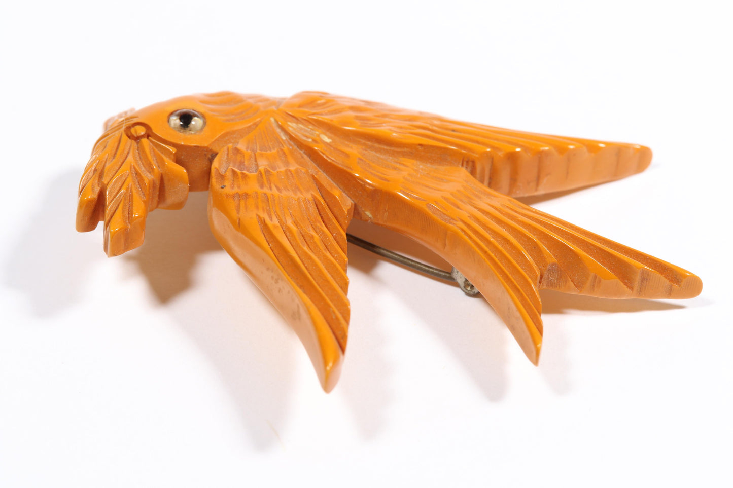 Vintage carved figural butterscotch Bakelite dove bird brooch with glass eyes. 2 1/2"H x 3"W