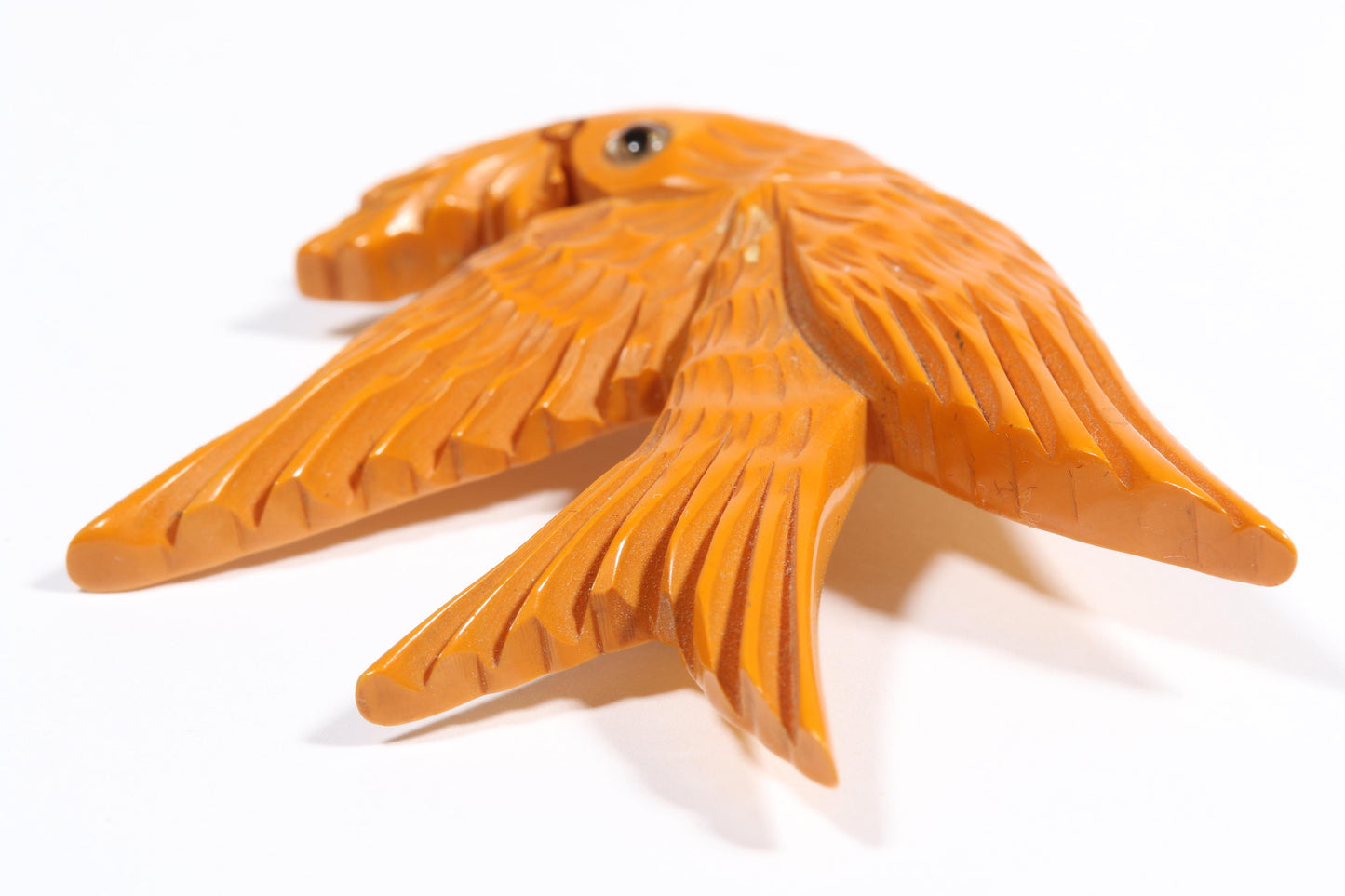 Vintage carved figural butterscotch Bakelite dove bird brooch with glass eyes. 2 1/2"H x 3"W