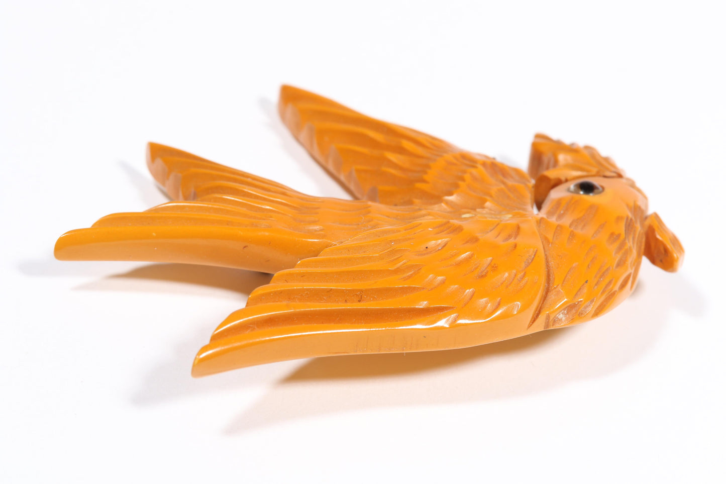 Vintage carved figural butterscotch Bakelite dove bird brooch with glass eyes. 2 1/2"H x 3"W