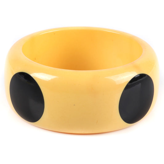Vintage Bakelite big dot WIDE bangle bracelet in butterscotch with 4 black polka dots. 2 1/2" inner diam., 1 1/2" W