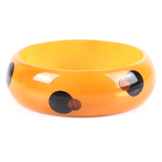 Vintage Bakelite overlapping dot pattern bangle bracelet. 2 1/2" inner diam, 1" W