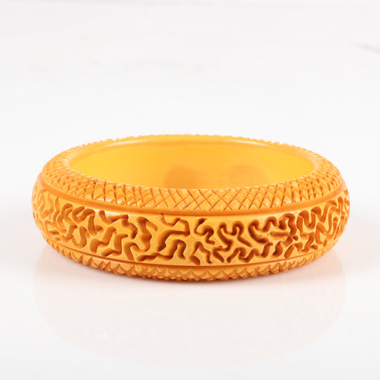 Vintage Bakelite carved butterscotch bangle bracelet with unusual random abstract pattern and cross hatch borders. 2 1/2" inner diam., 1" W