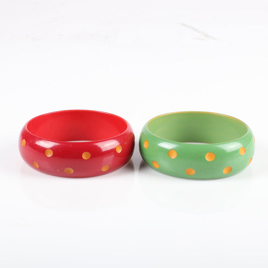 Vintage Galalith 2pc. over-dyed carved polka dot bangle bracelets, red and green with yellow dots. 2 1/2" inner diam., 1" W