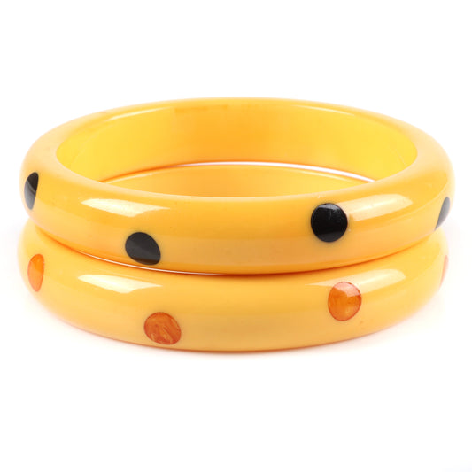Vintage Bakelite 2pc. laminated dot bangle bracelets in cream corn each with 8 marbled red and green hi-low polka dots. 2 1/2" inner diam., 1/2" W