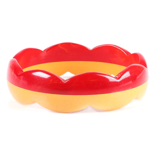 Vintage Bakelite laminated scallop carved bangle bracelet. Two color half marbled red and butterscotch. 2 1/2" inner diam., 1" W