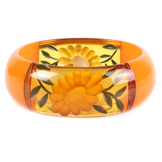 Vintage Bakelite chunky reverse carved and painted flower bangle bracelet with four laminated segments in butterscotch and apple juice. 2 1/2" inner diam., 1" W