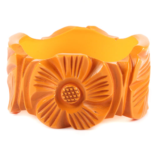 Vintage Bakelite WIDE shaped carved flower cuff bangle bracelet with alternating sunflower and leaf motif in butterscotch. 21/2" inner diam., 1 1/2" W