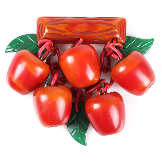 Vintage Bakelite fruit dangle brooch with over-dyed apple charms hanging from carved branch bar pin with celluloid chain and leaves. 3" H x 3 1/2" W