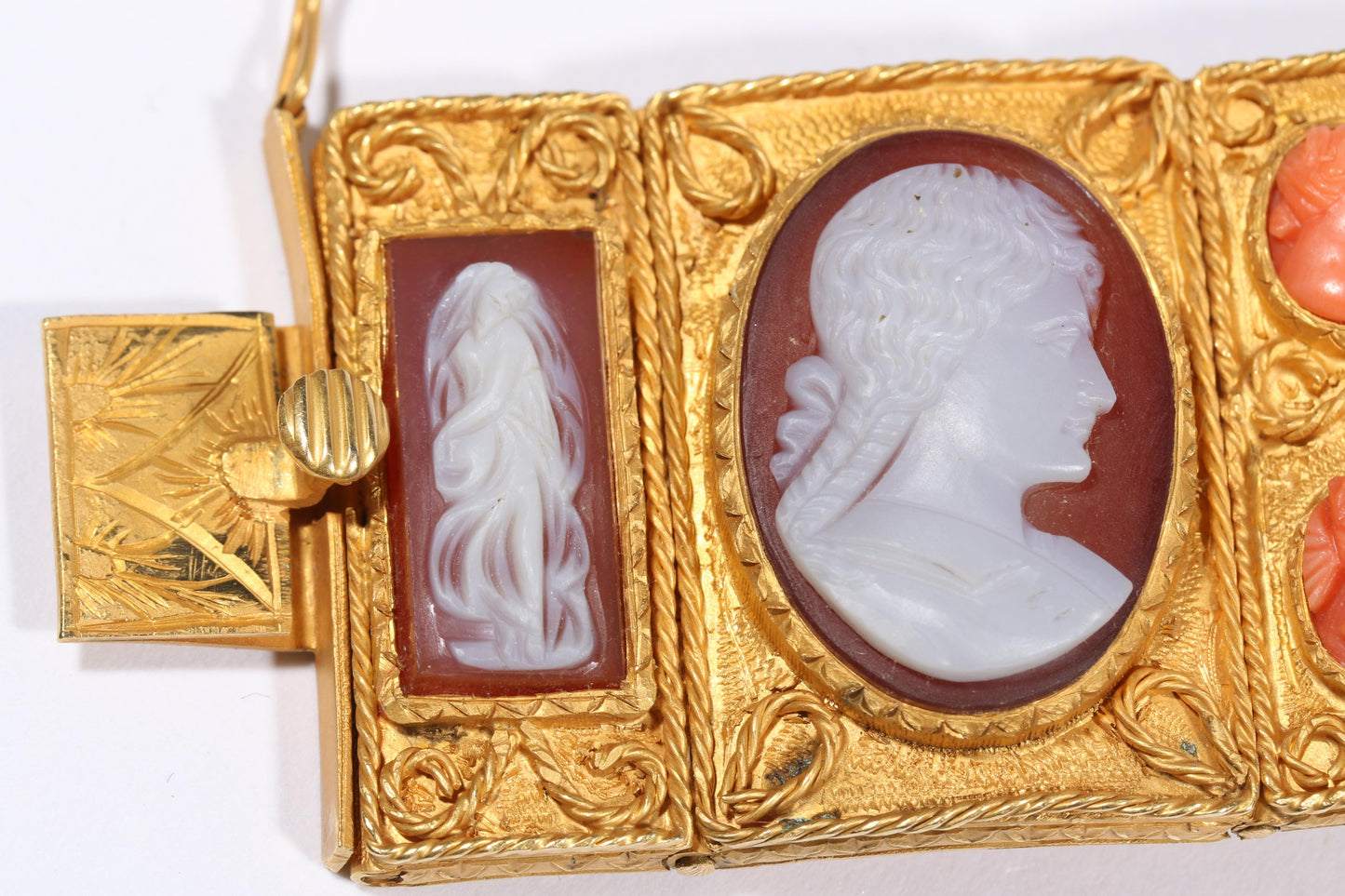Antique 18K yellow gold Victorian panel bracelet with 19 intricate left and right facing cameos carved from natural stone including tigers eye, onyx, coral, shell, and more. 8 1/4"L x 1 1/8"W