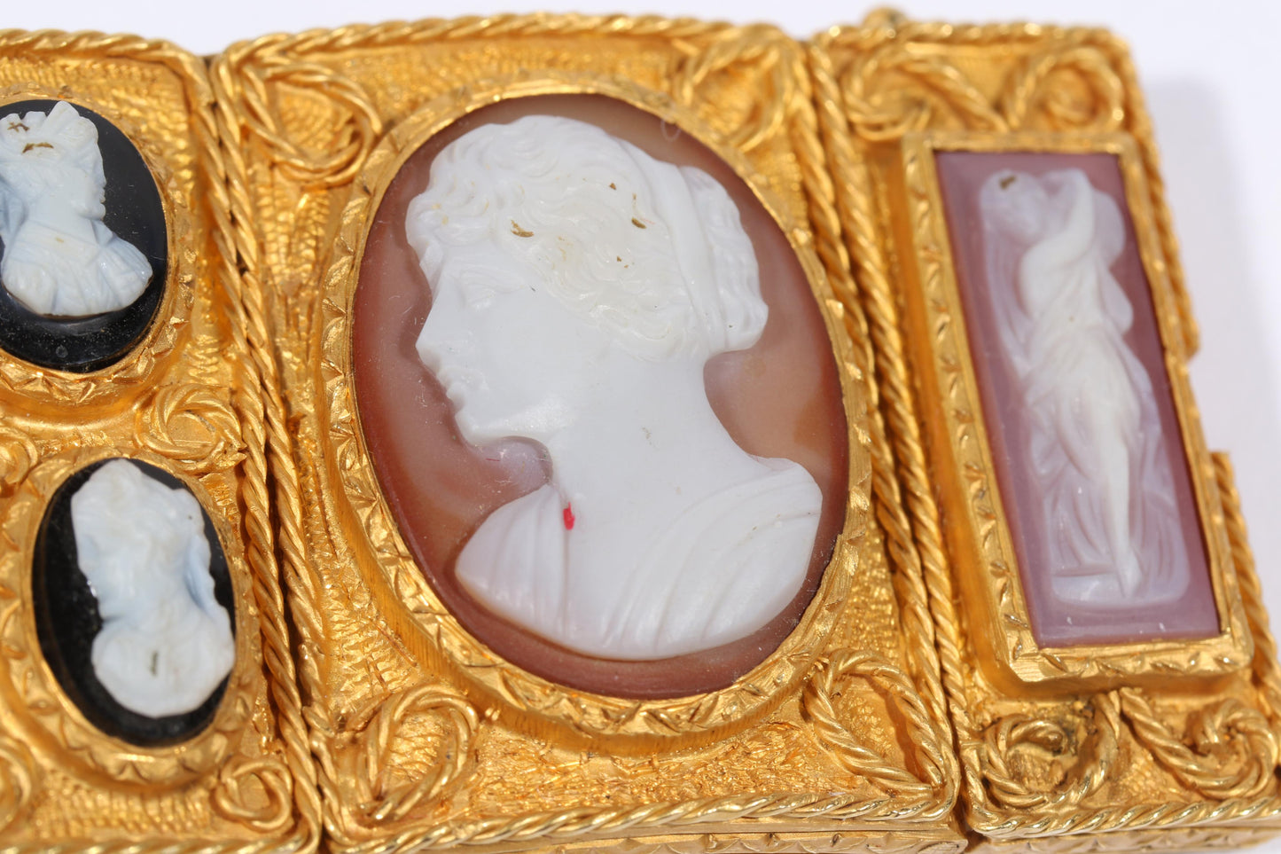Antique 18K yellow gold Victorian panel bracelet with 19 intricate left and right facing cameos carved from natural stone including tigers eye, onyx, coral, shell, and more. 8 1/4"L x 1 1/8"W