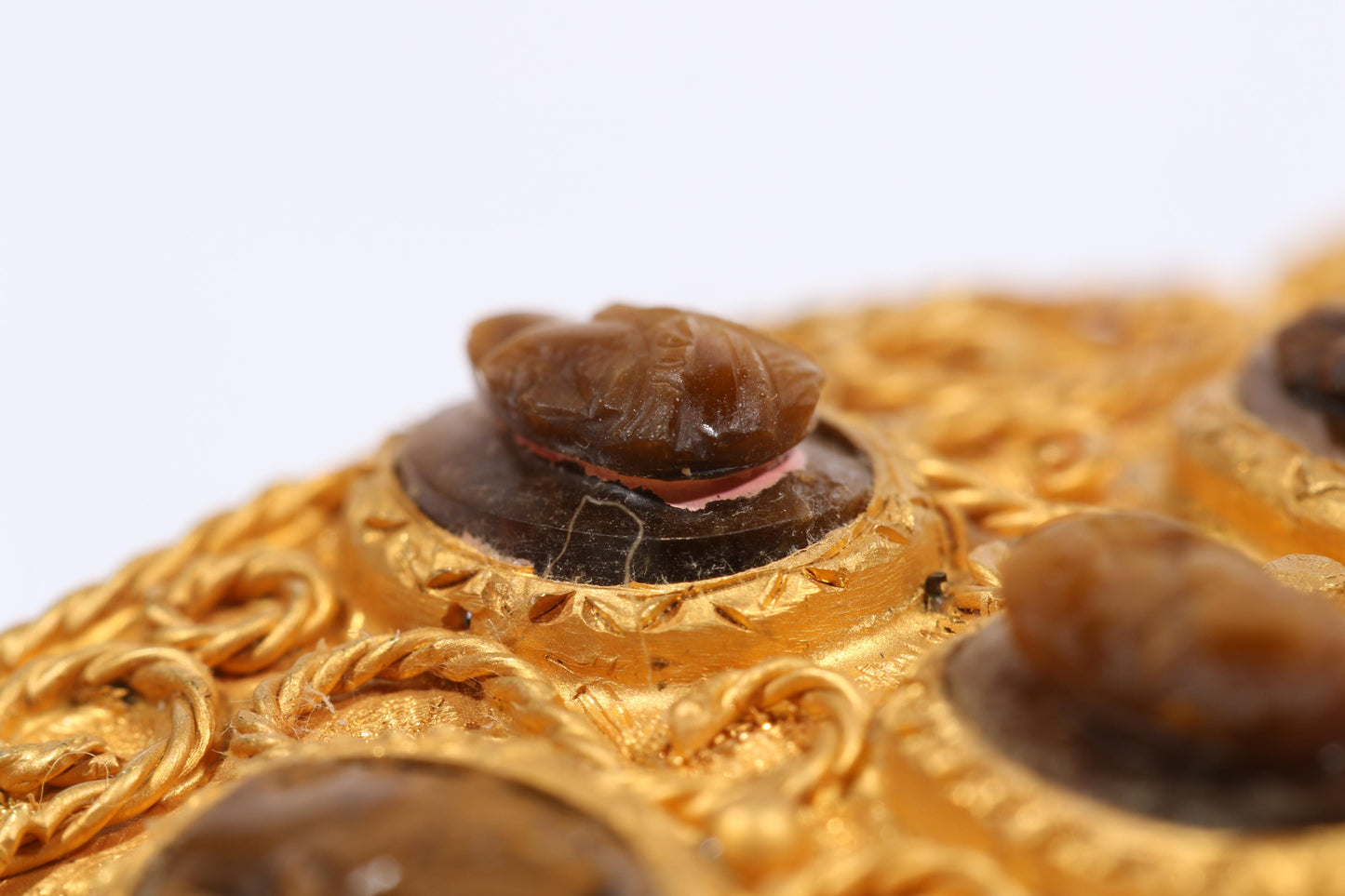 Antique 18K yellow gold Victorian panel bracelet with 19 intricate left and right facing cameos carved from natural stone including tigers eye, onyx, coral, shell, and more. 8 1/4"L x 1 1/8"W