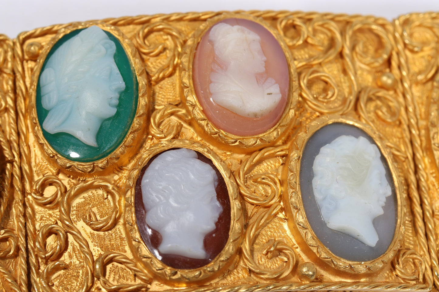 Antique 18K yellow gold Victorian panel bracelet with 19 intricate left and right facing cameos carved from natural stone including tigers eye, onyx, coral, shell, and more. 8 1/4"L x 1 1/8"W