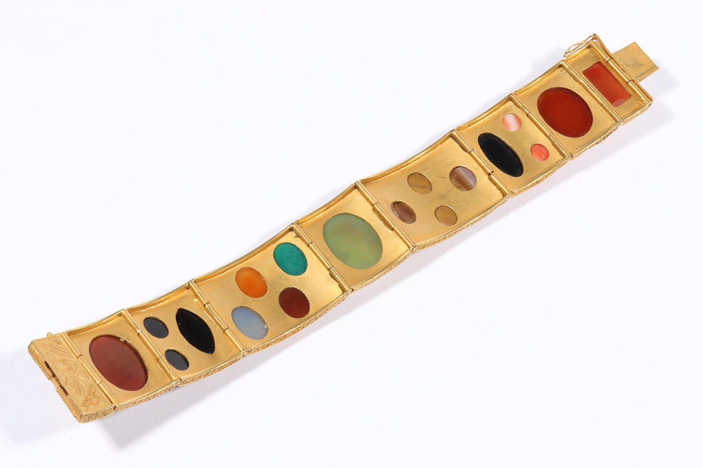 Antique 18K yellow gold Victorian panel bracelet with 19 intricate left and right facing cameos carved from natural stone including tigers eye, onyx, coral, shell, and more. 8 1/4"L x 1 1/8"W